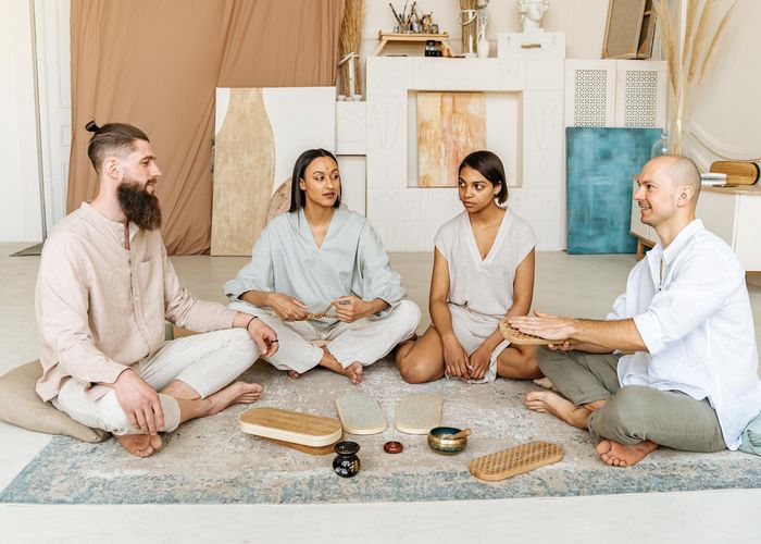Diverse group smiling during a relaxing yoga session.