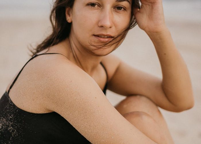 Woman in a peaceful meditation pose with soft lighting.